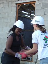 volunteers help build